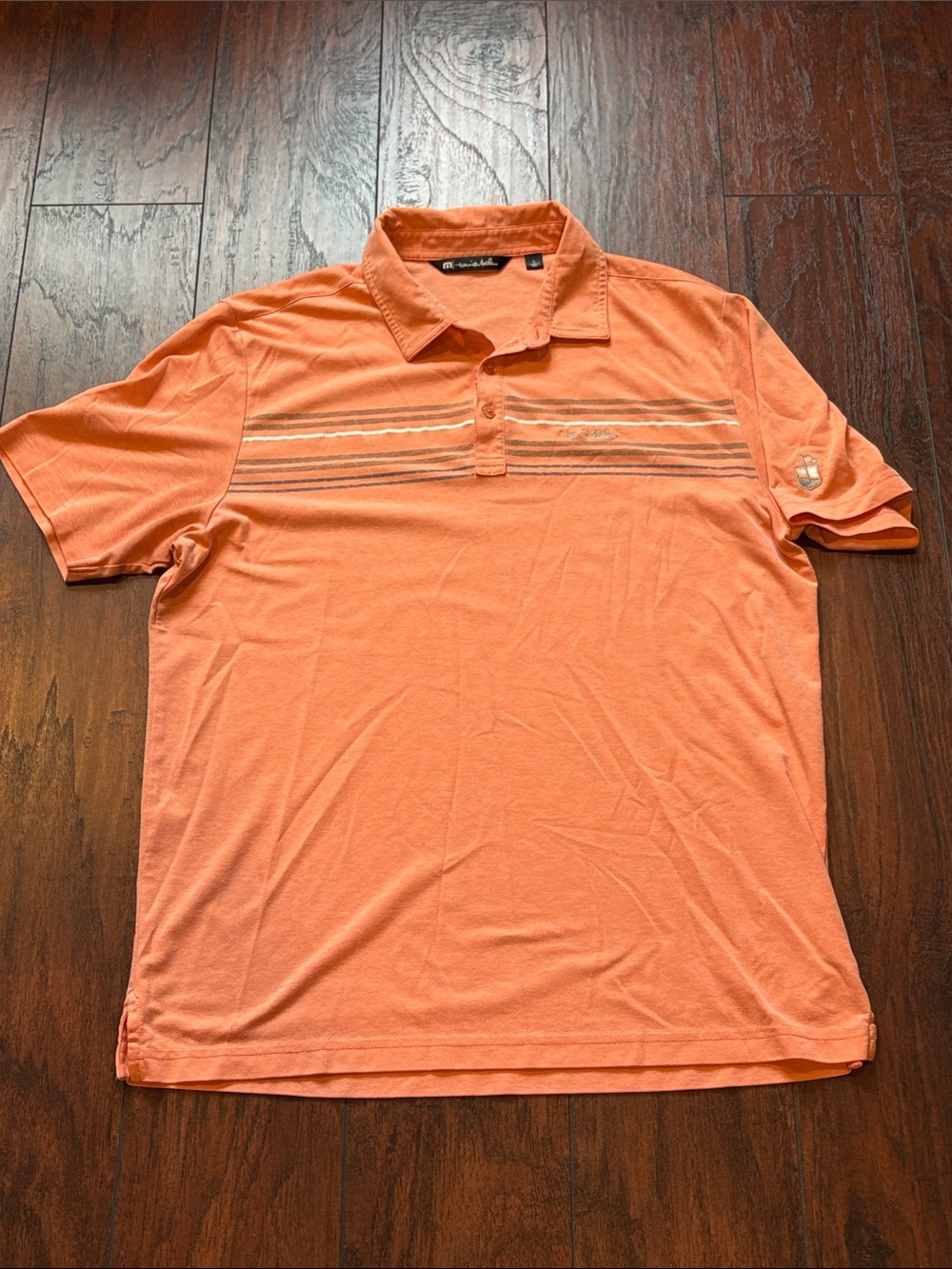 TravisMathew Coral Orange Polo with Subtle Chest Stripes